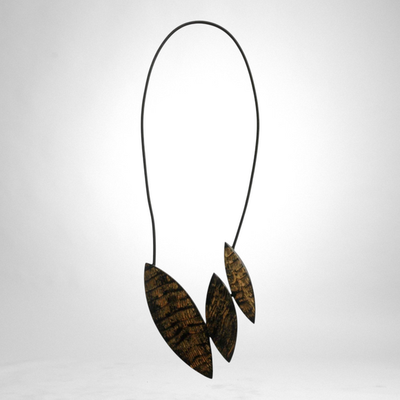 Style and Grace JUNO black necklace featuring three textured leaf-shaped pendants on a slim cord