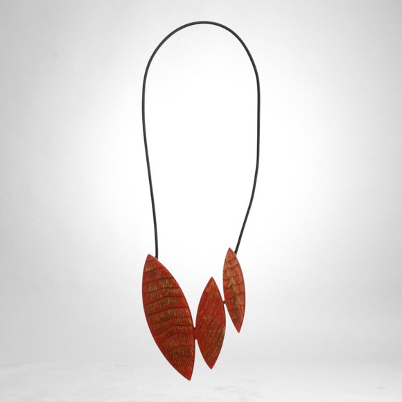 Style and Grace JUNO red necklace featuring three textured leaf-shaped pendants on a black cord