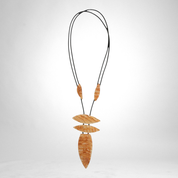 Style and Grace JUNO pendant necklace featuring five cream-colored carved wooden beads on a black adjustable cord