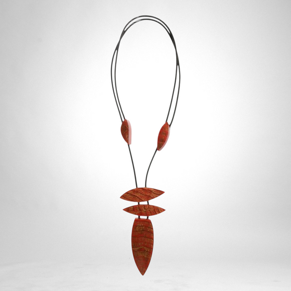 Style and Grace JUNO adjustable pendant necklace featuring five red textured leaf-shaped beads on a black cord.